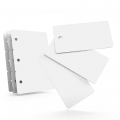 White PVC key tag cards with rounded corners and punched holes, shown fanned out