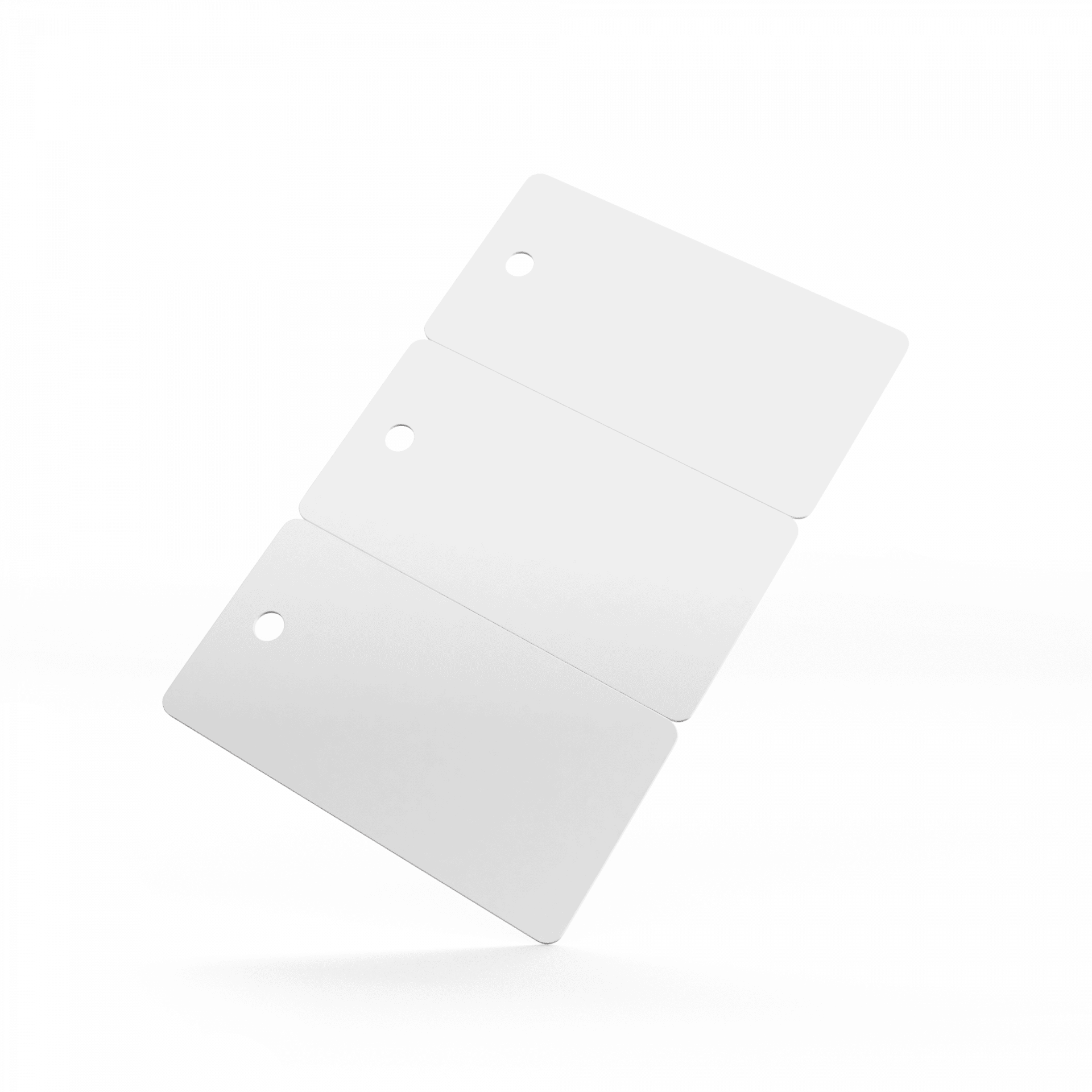 Three blank white PVC key tag cards with punched holes